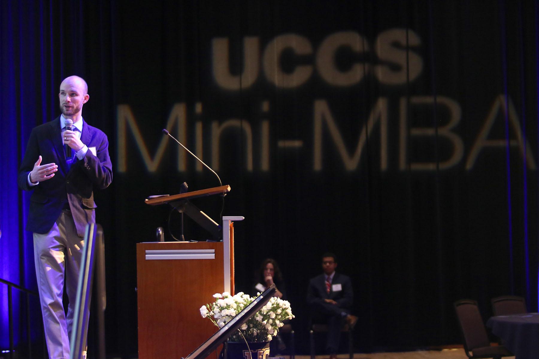 Photo of a Mini-MBA graduate presenting at the final event.