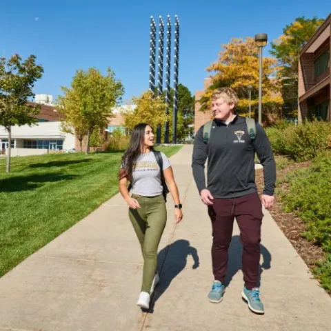 Two UCCS students walking across campus.