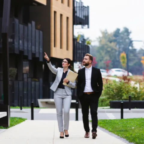 Two individuals examining a commercial property.