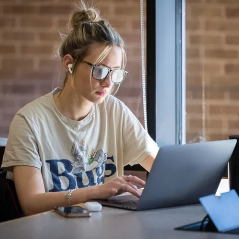 Female student studying on her laptop