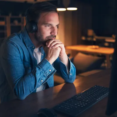 Man sitting in front of computer screen. 