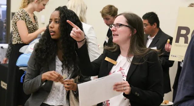 UCCS staff member offering assistance to student at Career Networking Night.