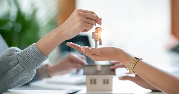 Real estate agent handing over keys