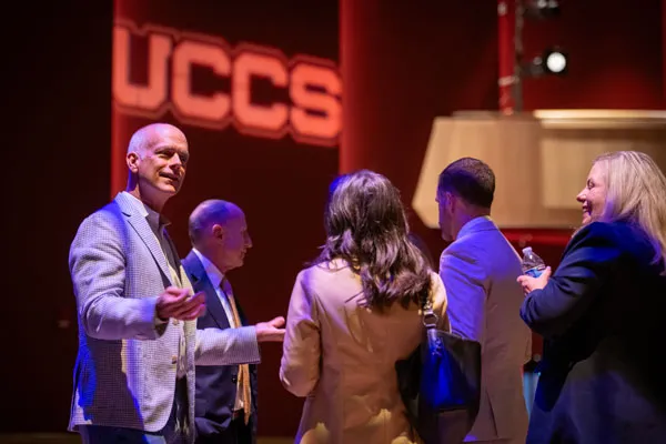 Photo of people talking at the 2025 UCCS Economic Forum