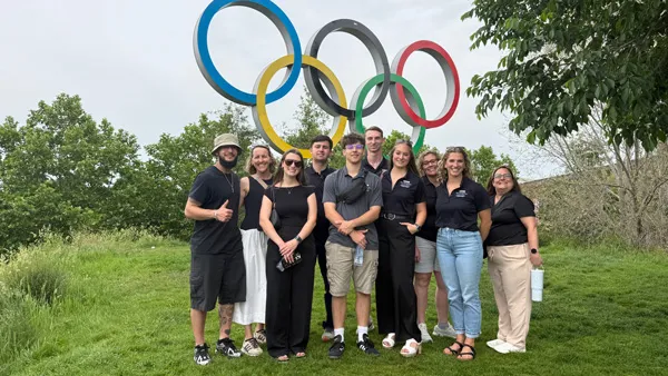 Students on study abroad trip in front of the Olympic rings