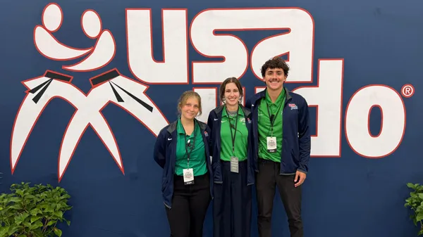 Photo of students in front of USA Judo banner